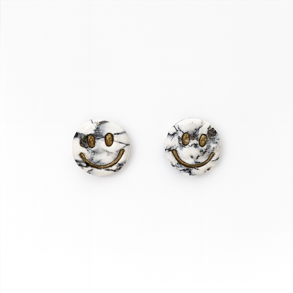 Handmade polymer clay howlite effect smiley earrings with gold leaf and glossy stone-effect finish.