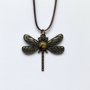 Handmade Camo Style Dragonfly Necklace featuring a bronze dragonfly pendant with marbled brown, light green, and olive green polymer clay and gold foil accents on a brown rope chain.