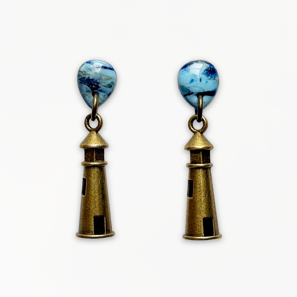 Handmade Deep Blue Lighthouse Earrings featuring marbled blue polymer clay teardrop studs with antique bronze lighthouse charms.